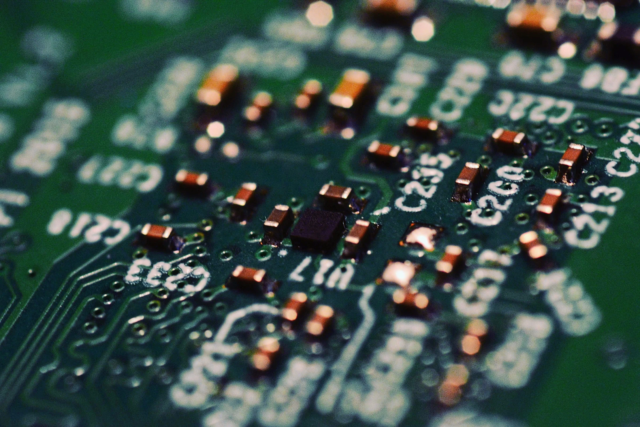 Macro photograph of components on a green printed circuit board