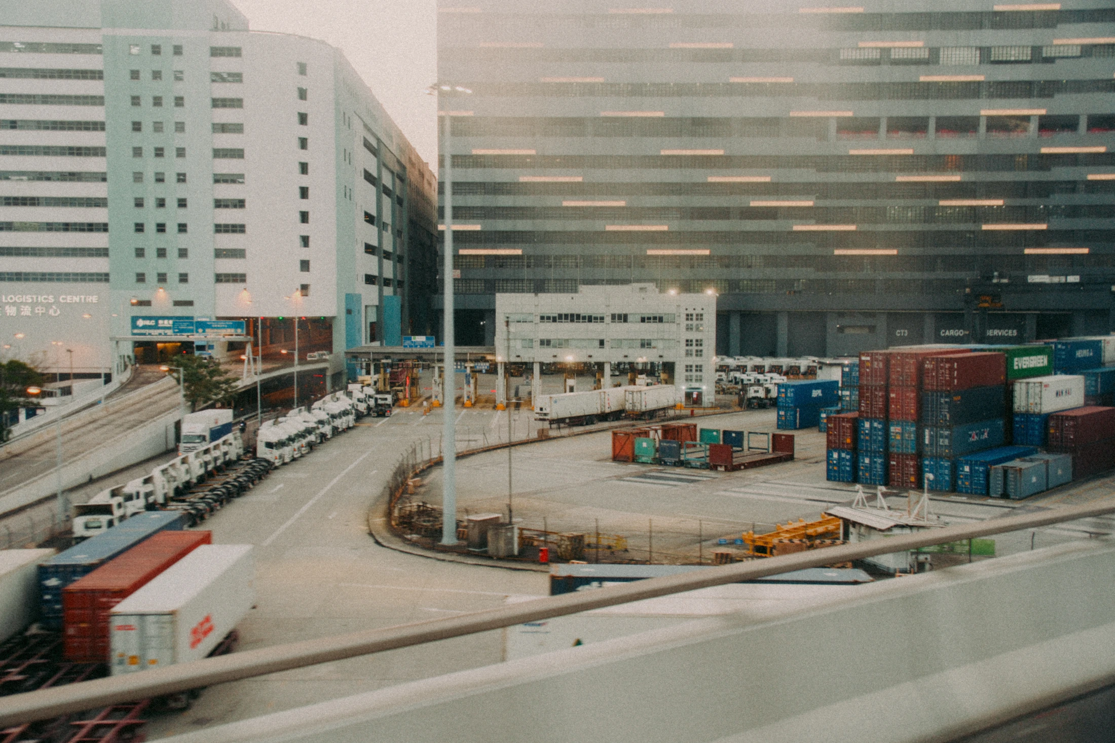 Shipping containers and freight vehicles at a Hong Kong logistics hub