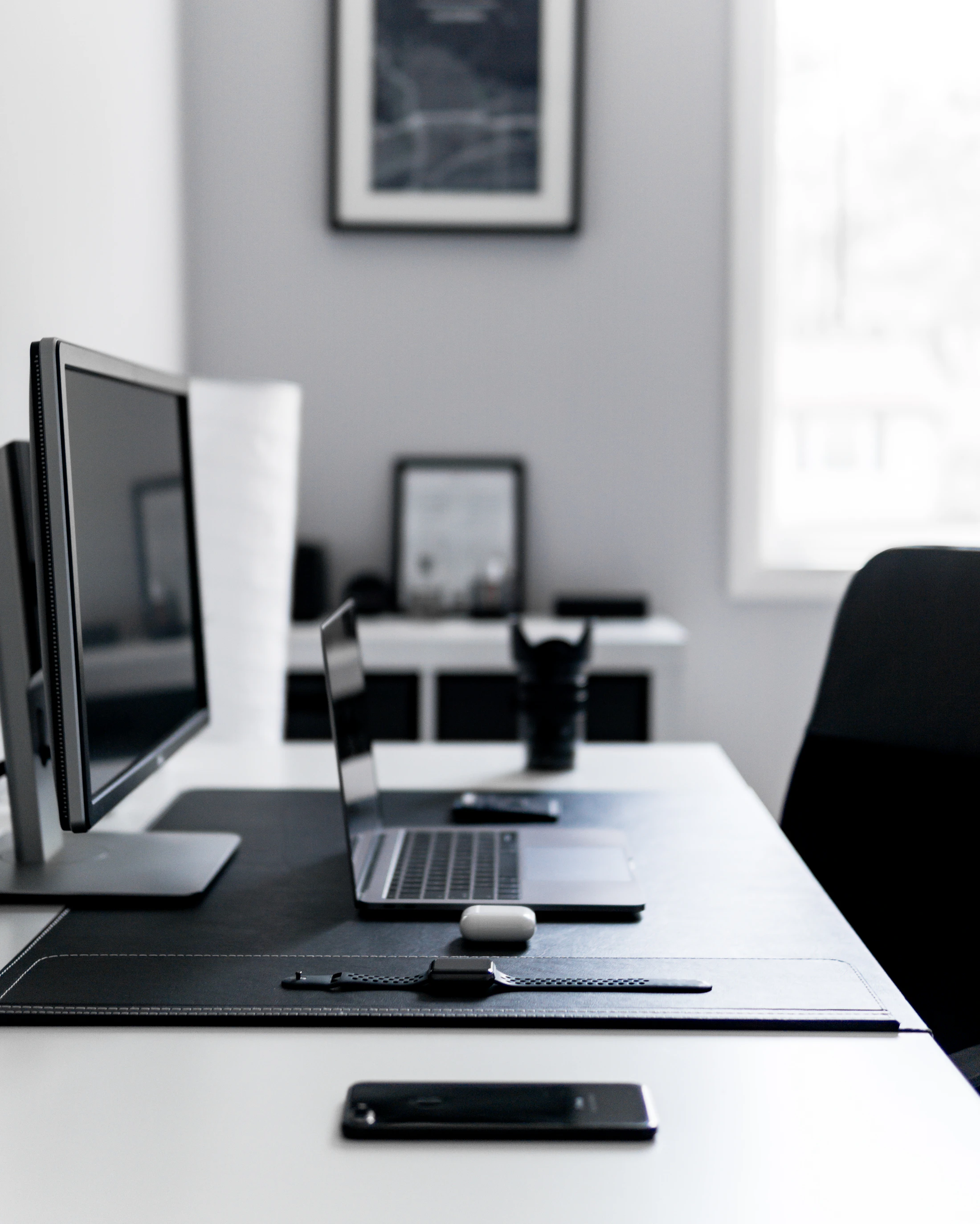 Laptop and personal devices arranged on a desk